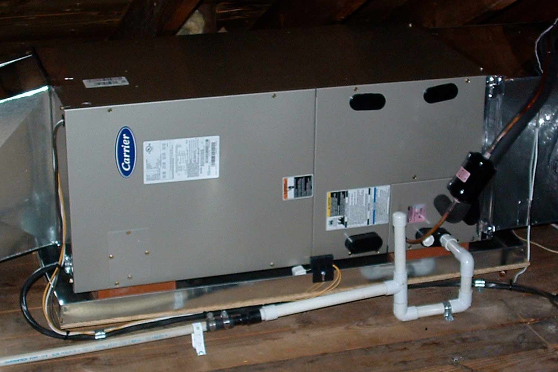 An air conditioner in an attic with a metal AC drip pan underneath (Photo by: Glen Engel-Cox via Flickr) An air conditioner in an attic with a metal AC drip pan underneath (Photo by: Glen Engel-Cox via Flickr)