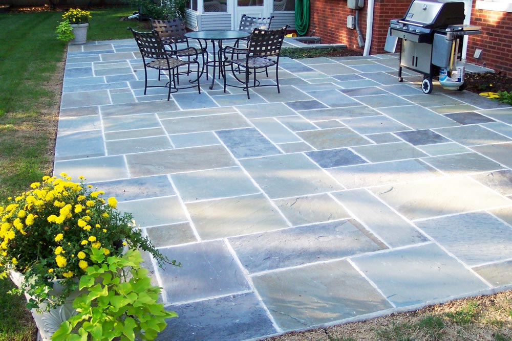 A bluestone patio in a residential backyard.