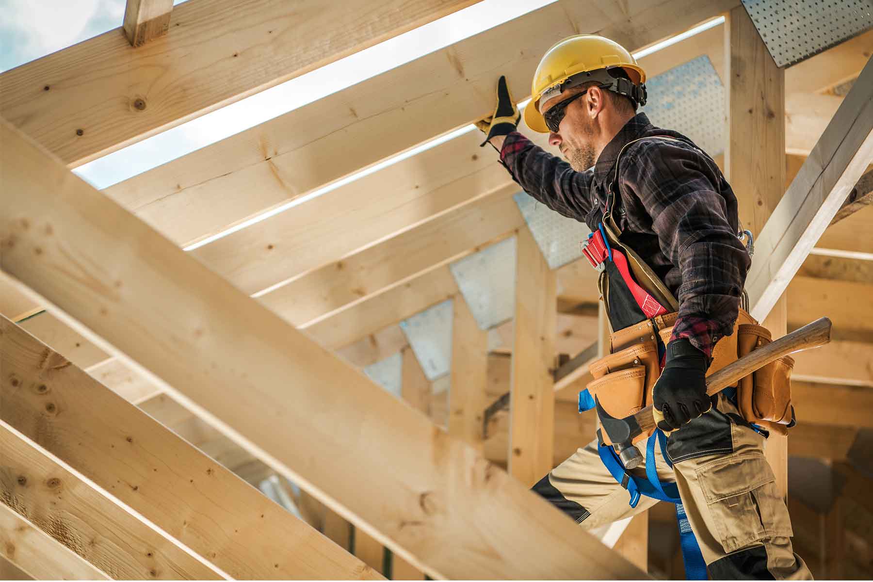 A carpenter working on roof frame construction
