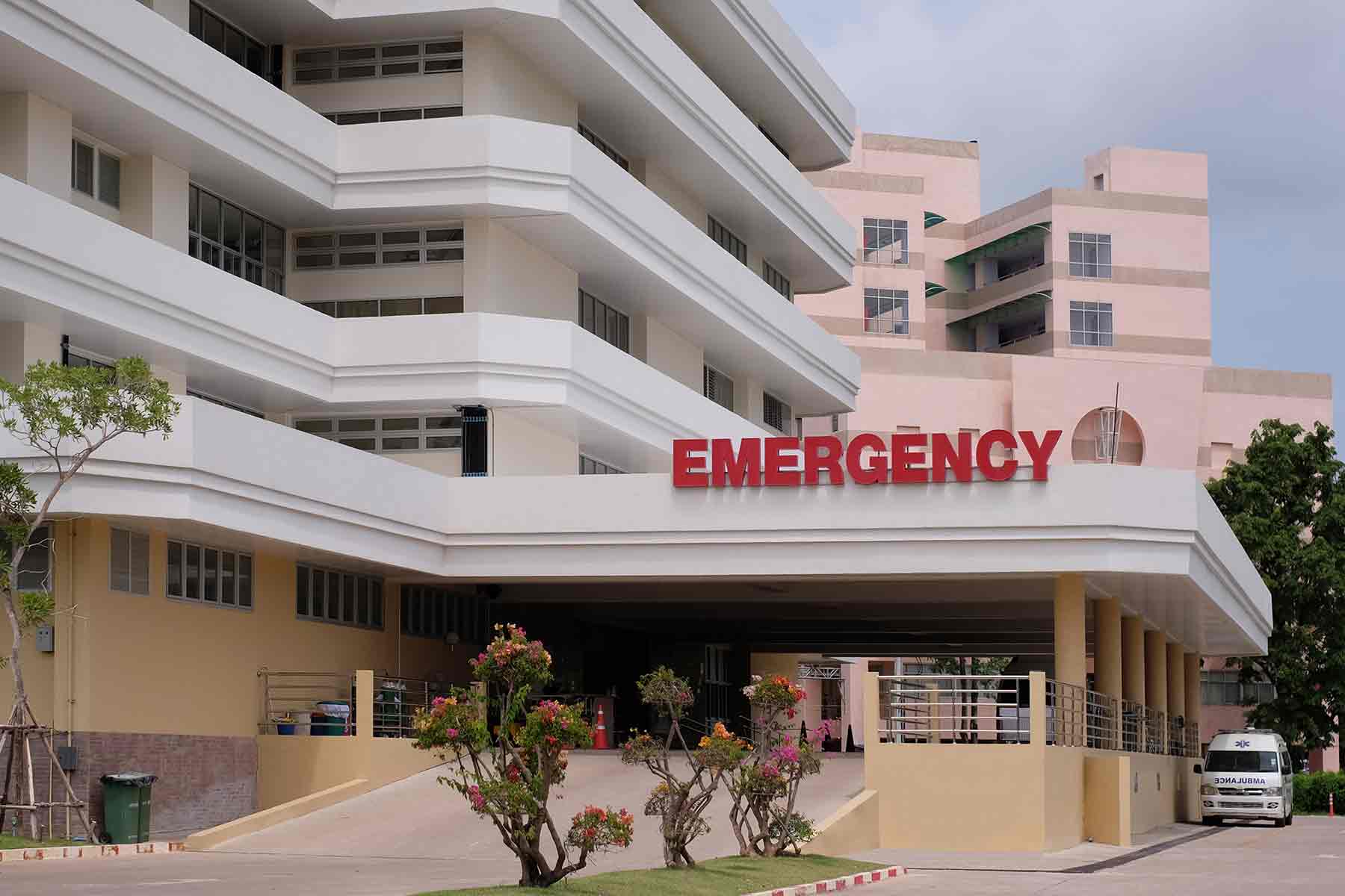 A modern hospital building with ambulance car and entrance to emergency room