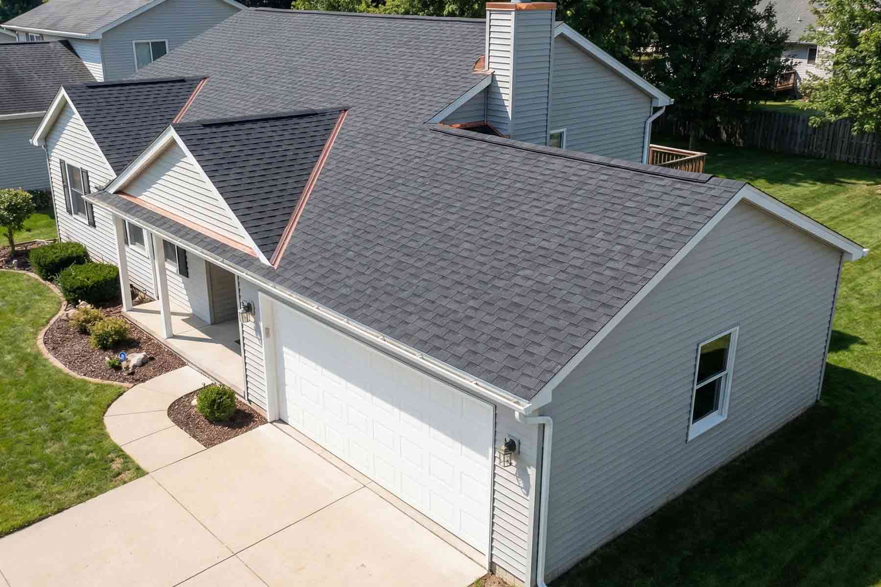 An aerial view of a newly replaced garage roof on a residential house