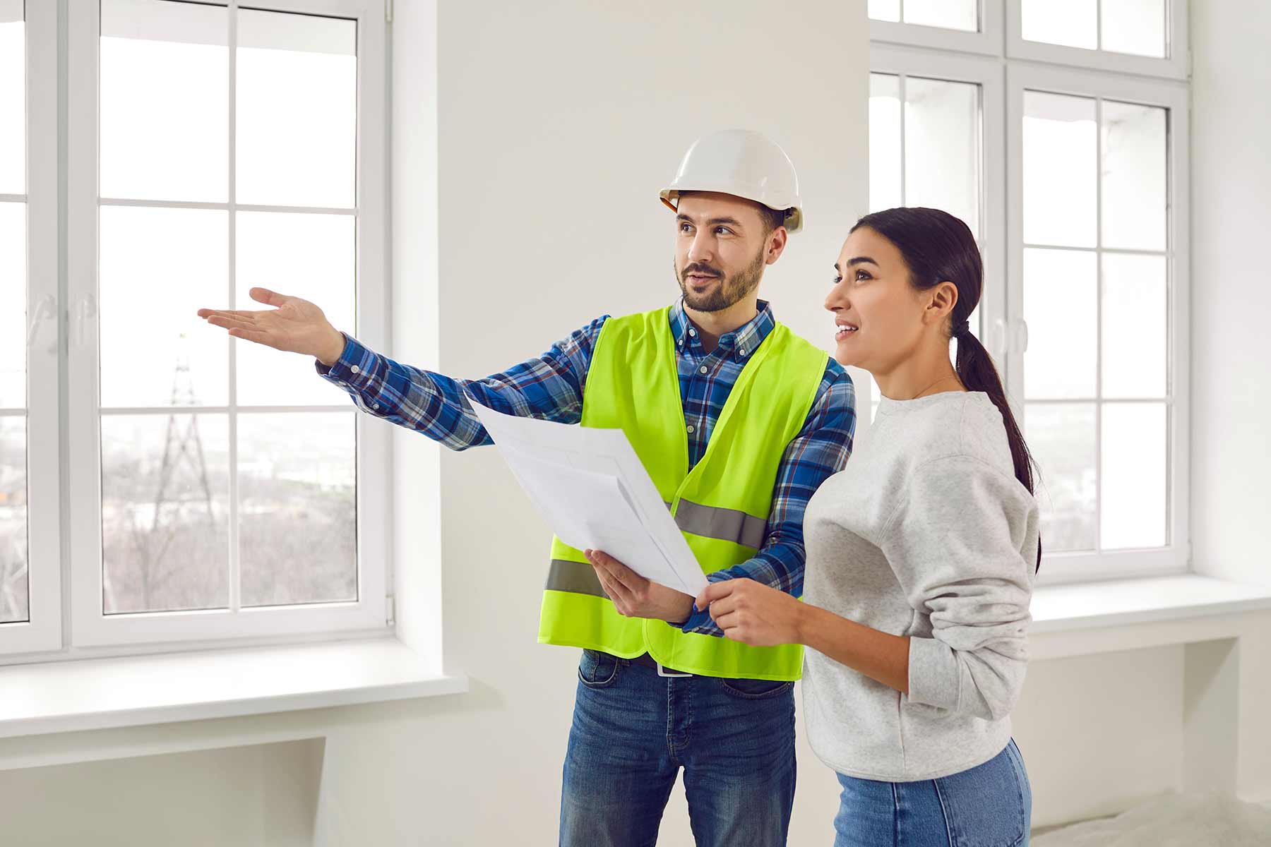 A foreman discusses home improvement and renovation plans with a client