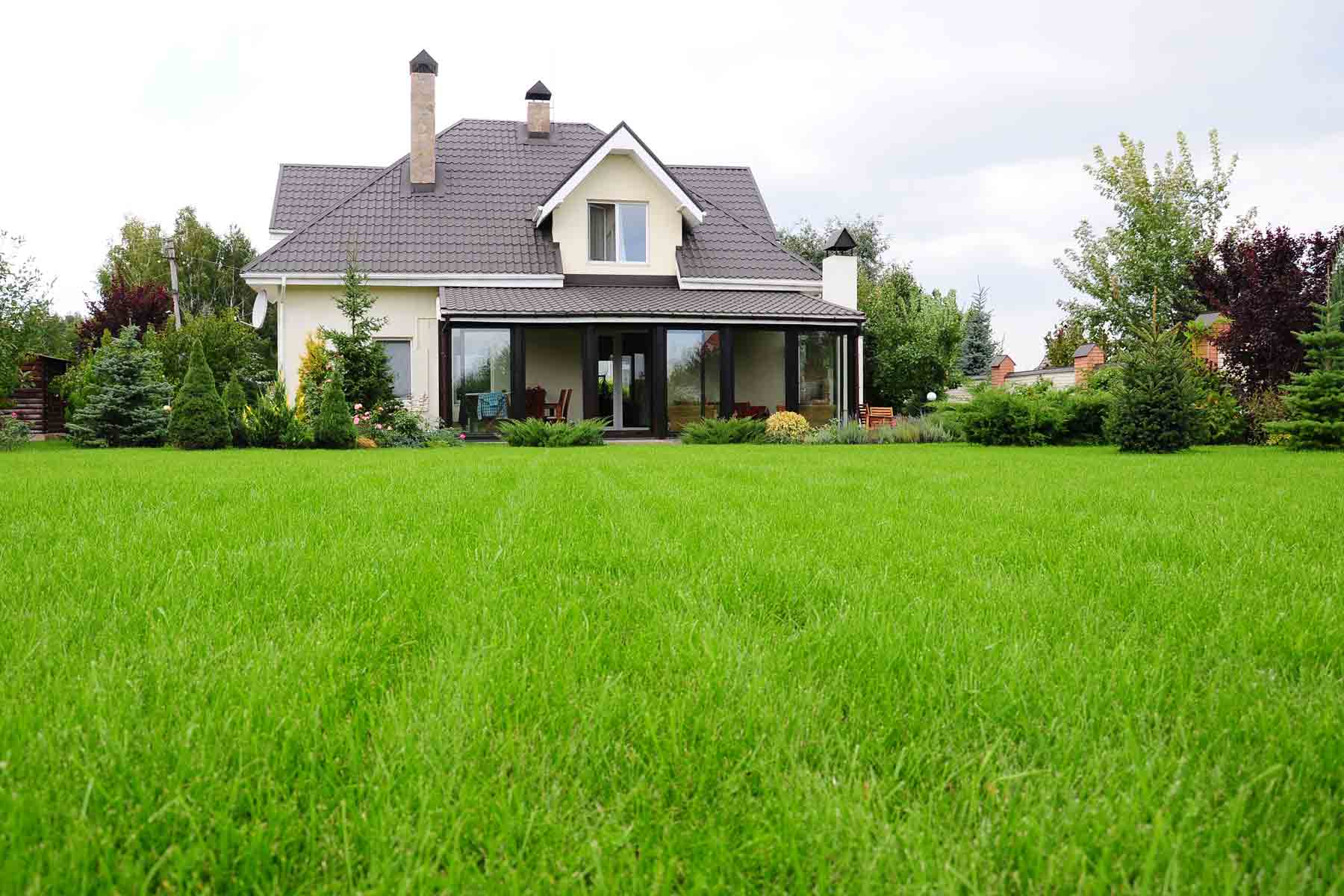 A home with a lush green lawn with healthy grass