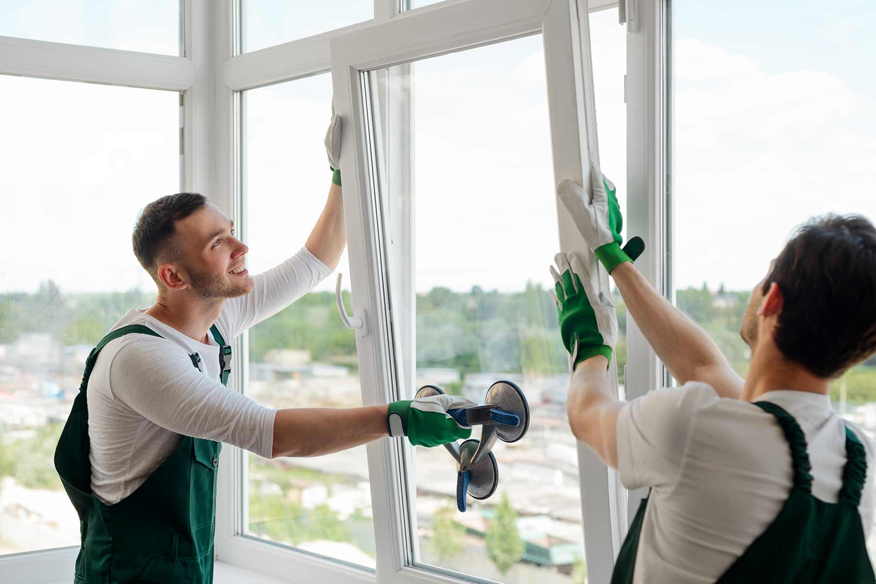 Two workers installing a new window sash during the replacement process